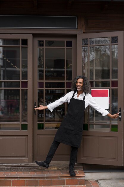 Full shot smiley man wearing apron