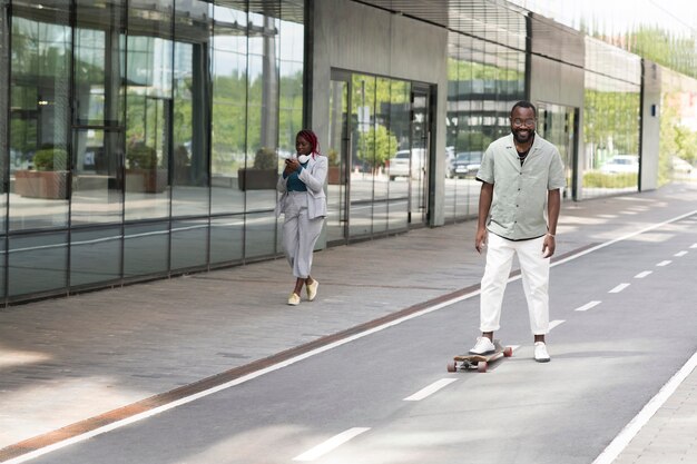 Full shot smiley man with skateboard