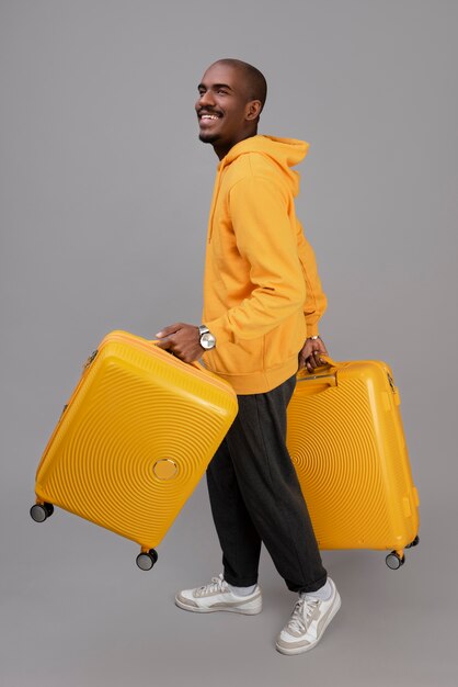 Full shot smiley man with yellow baggage