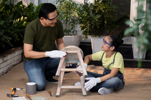 Full shot smiley man and woman reusing chair