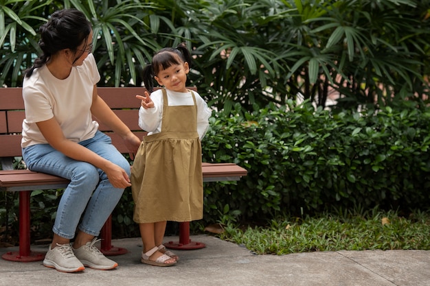 Free photo full shot smiley mother and girl outdoors