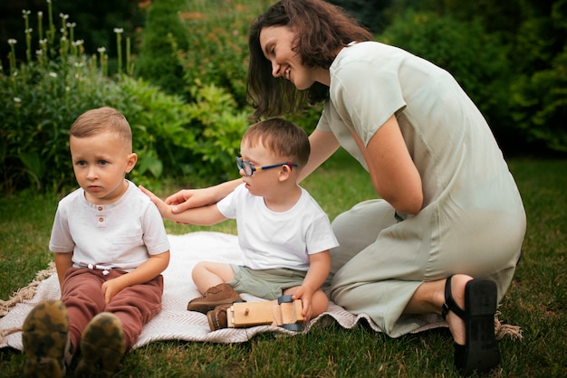 Free photo full shot smiley mother and kids