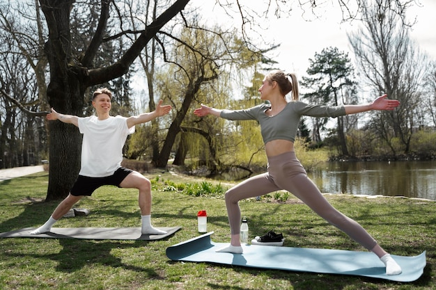 Full shot smiley people exercising together