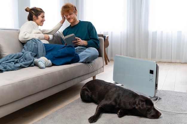 Full shot smiley pregnant woman and man on couch