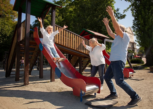 Full shot smiley senior woman on slide