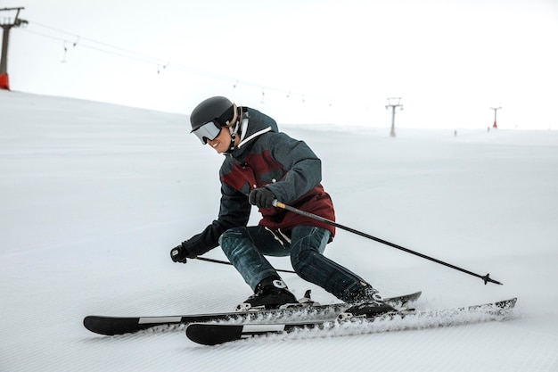 Free photo full shot smiley skier with equipment