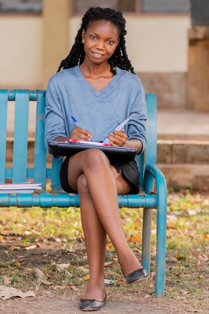 Full shot smiley woman on bench