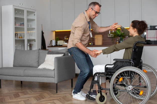 Full shot smiley woman dancing in wheelchair