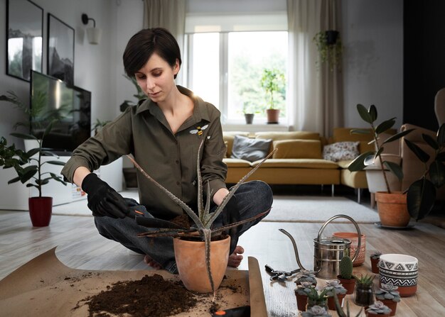 Full shot smiley woman gardening at home