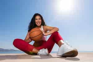 Free photo full shot smiley woman holding ball