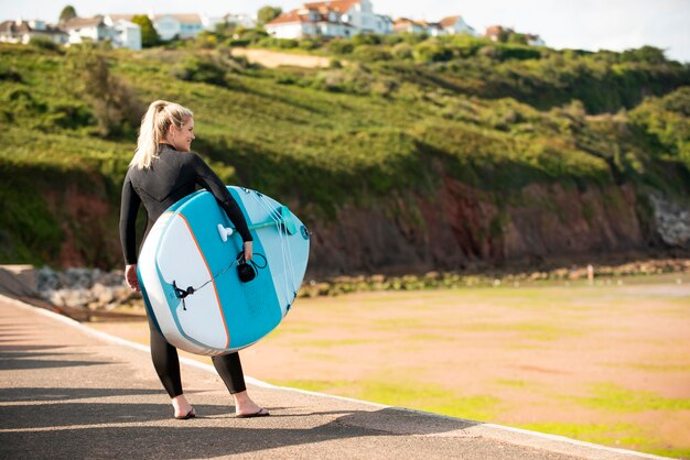 Full shot smiley woman holding board