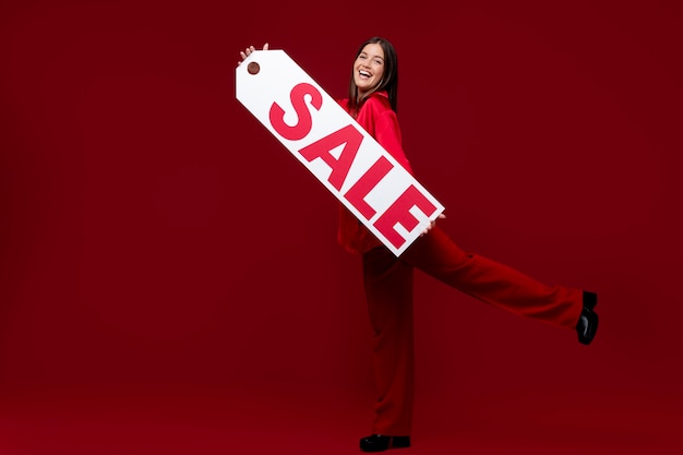 Full shot smiley woman holding sale sign