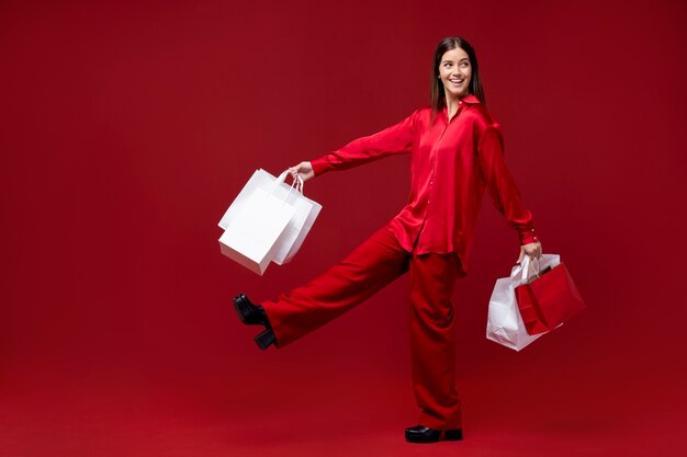 Full shot smiley woman holding shopping bags