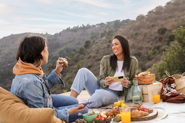 Full shot smiley woman holding smartphone