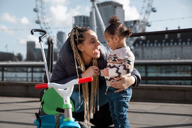 Free photo full shot smiley woman and kid outdoors