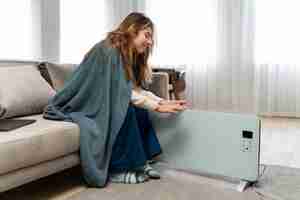 Free photo full shot smiley woman near heater