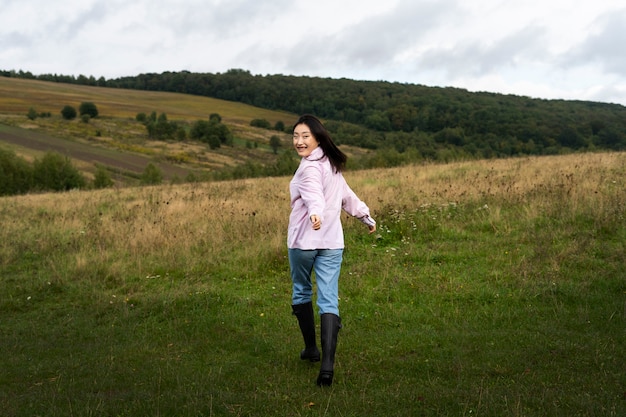Full shot smiley woman outdoors