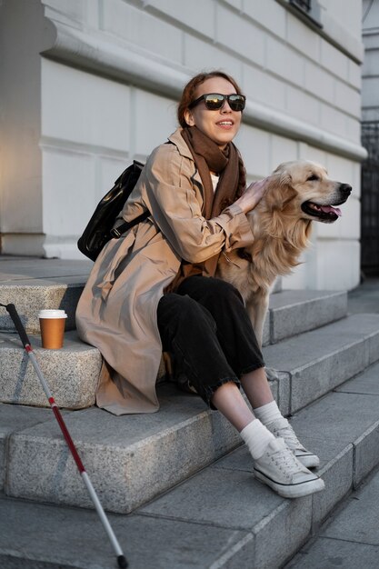 Full shot smiley woman petting dog