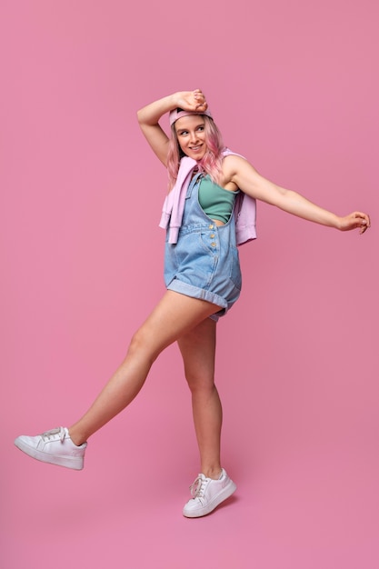 Full shot smiley woman posing in studio