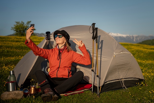 Full shot smiley woman taking selfie