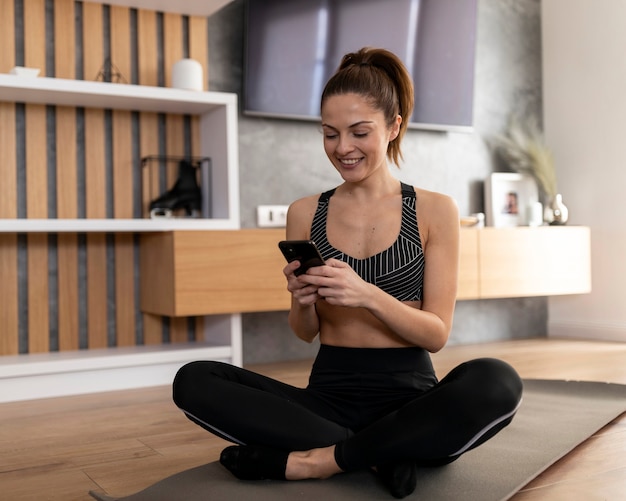 Full shot smiley woman texting