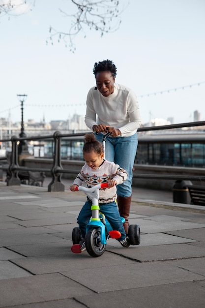 Full shot smiley woman walking with child