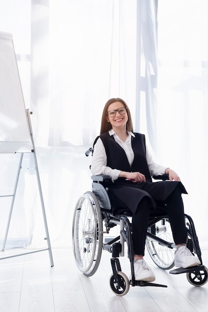 Free photo full shot smiley woman in wheelchair