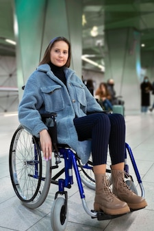Full shot smiley woman in wheelchair