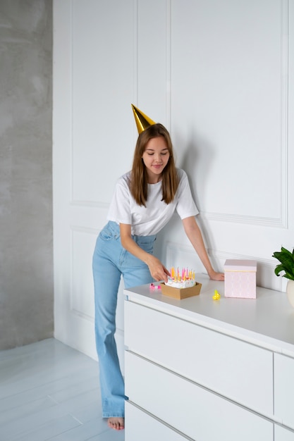 Free photo full shot smiley woman with cake