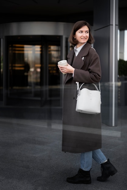 Free photo full shot smiley woman with cup