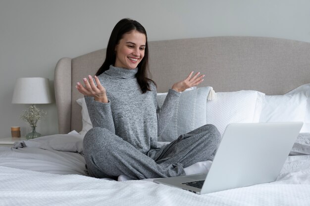 Full shot smiley woman with laptop