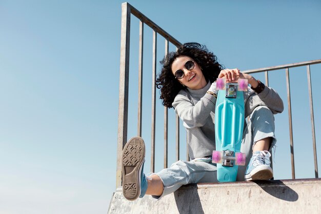 Full shot smiley woman with penny board