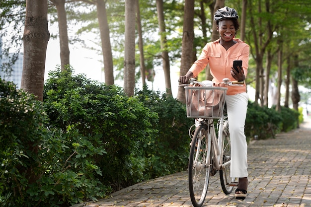 Full shot smiley woman with smartphone