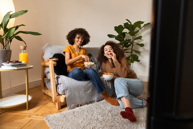 Full shot smiley women at home