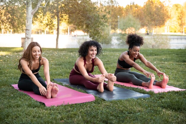 Full shot smiley women stretching