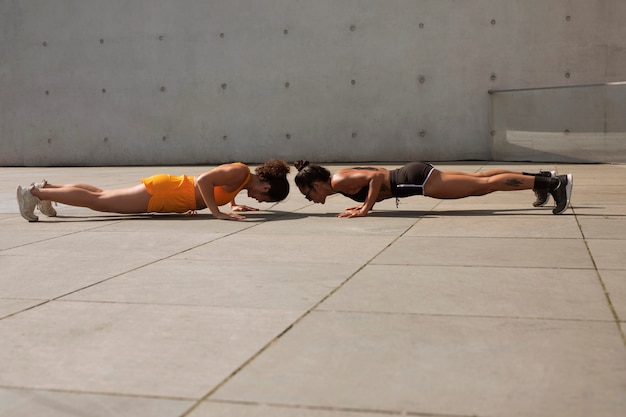 Full shot smiley women training together