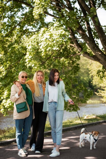 Full shot smiley women walking dog