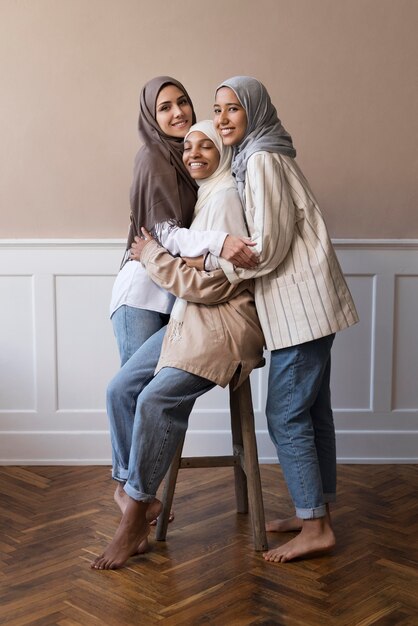 Full shot smiley women wearing hijab