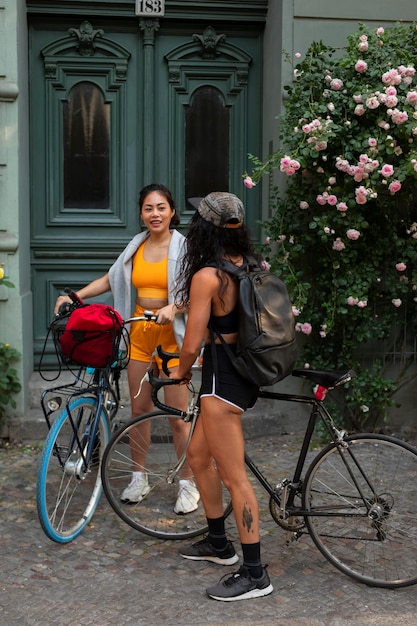 Full shot smiley women with bicycles