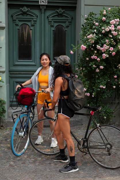 Full shot smiley women with bicycles