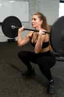 Free photo full shot strong woman training at gym