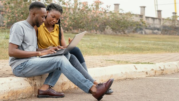 Full shot students studying together