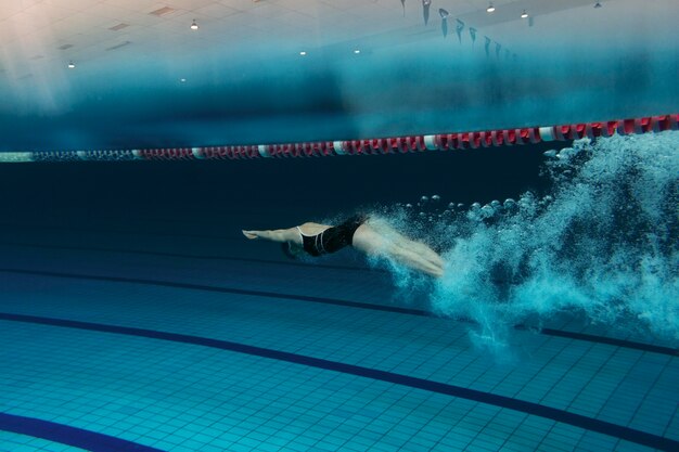 Full shot swimmer with equipment in pool