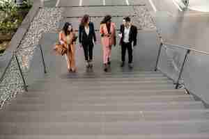 Free photo full shot team walking up the stairs