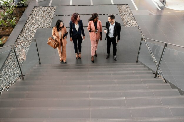 Full shot team walking up the stairs