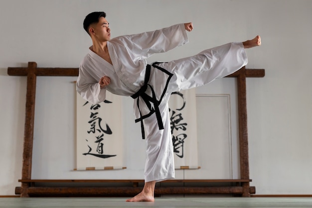 Full shot teen practicing taekwondo