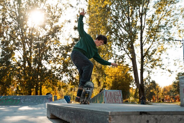 Full shot teen with skateboard outdoors