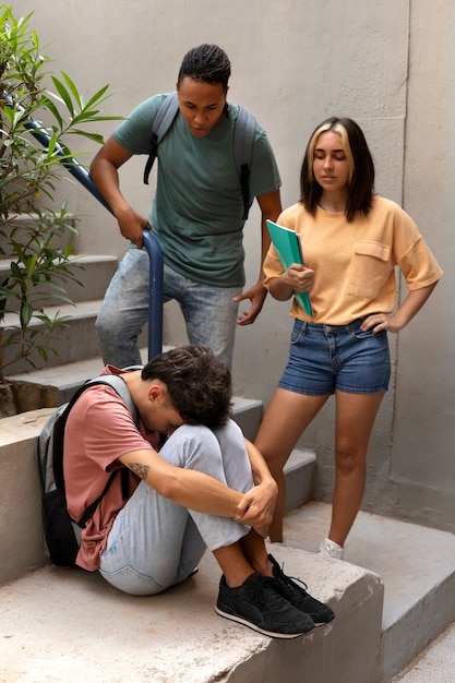 Full shot  teens bullying colleague