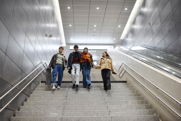 Full shot teens climbing down stairs