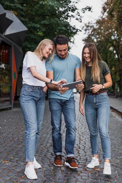 Full-shot teens looking in a tablet